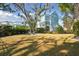 Spacious backyard with a large grassy area and a charming blue house beyond the fence at 2514 Bullock Guard Dr, Johns Island, SC 29455