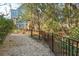 Backyard with a black metal fence and crushed stone at 2514 Bullock Guard Dr, Johns Island, SC 29455