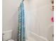 Bathroom with tub/shower combination featuring white tile and blue decorative shower curtain at 2514 Bullock Guard Dr, Johns Island, SC 29455