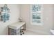 Bright bathroom with vanity desk, drawers, stool, hexagon tile floor and plantation window at 2514 Bullock Guard Dr, Johns Island, SC 29455