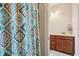 Bathroom with light-colored walls, wood cabinets and modern sink and faucet, viewed through door at 2514 Bullock Guard Dr, Johns Island, SC 29455