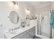 Bright bathroom with double sinks, vanity, modern fixtures, and glass shower at 2514 Bullock Guard Dr, Johns Island, SC 29455