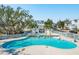 Inviting community pool with palm trees and a clubhouse, perfect for relaxation and social gatherings at 2514 Bullock Guard Dr, Johns Island, SC 29455