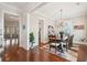 Bright dining room with a chandelier, hardwood floors, and a large wooden table set for dinner at 2514 Bullock Guard Dr, Johns Island, SC 29455