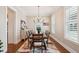 Dining room features a wooden table, decorative chandelier, colorful rug and an American flag on the wall at 2514 Bullock Guard Dr, Johns Island, SC 29455