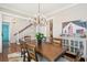 Dining room with wooden table, chandelier, and a display cabinet with a painting on the wall at 2514 Bullock Guard Dr, Johns Island, SC 29455