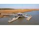 Aerial view of a dock on the water with a covered gazebo, perfect for fishing and enjoying the scenery at 2514 Bullock Guard Dr, Johns Island, SC 29455