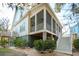 Beautiful elevated home featuring a screened-in porch, painted white with gray trim at 2514 Bullock Guard Dr, Johns Island, SC 29455