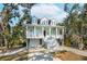 Beautiful two-story house with a spacious front porch, white stairs, and a lovely landscaped yard at 2514 Bullock Guard Dr, Johns Island, SC 29455