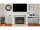 Close-up of the fireplace with mosaic tile surround and custom cabinets and marble countertop at 2514 Bullock Guard Dr, Johns Island, SC 29455