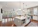 Open kitchen featuring a center island with quartz countertop, pendant lights, stainless appliances, and hardwood floors at 2514 Bullock Guard Dr, Johns Island, SC 29455