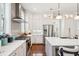 Modern kitchen with stainless appliances, gray backsplash, white cabinets and island seating at 2514 Bullock Guard Dr, Johns Island, SC 29455