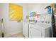 Well-lit laundry room featuring a washer, dryer, and wall art at 2514 Bullock Guard Dr, Johns Island, SC 29455