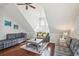 Cozy living room with vaulted ceiling, ceiling fan, hardwood floors, and gray sofas at 2514 Bullock Guard Dr, Johns Island, SC 29455