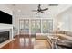 Living room with hardwood floors, fireplace, ceiling fan, recessed lights and floor to ceiling doors at 2514 Bullock Guard Dr, Johns Island, SC 29455