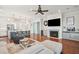 Cozy living room with a fireplace, TV, hardwood floors, and easy access to the modern kitchen at 2514 Bullock Guard Dr, Johns Island, SC 29455
