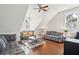 Bright living room with high angled ceiling, wood floors, ceiling fan, and sofas at 2514 Bullock Guard Dr, Johns Island, SC 29455