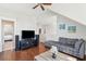 Open living room with vaulted ceiling, ceiling fan, hardwood floors, and gray sofas at 2514 Bullock Guard Dr, Johns Island, SC 29455