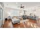 Open-concept living room with hardwood floors and a gray sectional sofa adjacent to the modern kitchen at 2514 Bullock Guard Dr, Johns Island, SC 29455