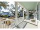 Covered porch offers a scenic neighborhood view, complemented by white railings and porch columns at 2514 Bullock Guard Dr, Johns Island, SC 29455