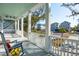 Relaxing porch with rocking chairs offers neighborhood views and features a stylish, painted floor at 2514 Bullock Guard Dr, Johns Island, SC 29455