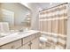 Bright bathroom features a large mirror, vanity with sink, and neutral striped shower curtain at 2905 Cavalcade Cir, Johns Island, SC 29455