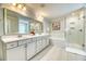 Bright bathroom features double sinks, a separate shower and tub, and lots of natural light at 2905 Cavalcade Cir, Johns Island, SC 29455