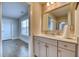 Bathroom vanity with a light countertop, decorative mirror, and access to the next room at 2905 Cavalcade Cir, Johns Island, SC 29455