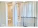 Bright bathroom features shower and tub combination with stylish striped curtain and neutral paint at 2905 Cavalcade Cir, Johns Island, SC 29455