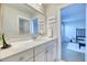 Bright bathroom featuring a vanity with large mirror and modern fixtures with a view to the bedroom at 2905 Cavalcade Cir, Johns Island, SC 29455
