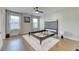 Bright bedroom with a modern ceiling fan, hardwood floors, and large windows providing ample natural light at 2905 Cavalcade Cir, Johns Island, SC 29455