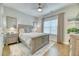 Comfortable bedroom featuring a large bed, nightstands, and a window for natural light at 2905 Cavalcade Cir, Johns Island, SC 29455