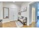Inviting entryway featuring a bench, coat closet, hardwood floors, and a decorative mirror at 2905 Cavalcade Cir, Johns Island, SC 29455