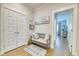 Welcoming entryway featuring a bench, coat closet, hardwood floors, and stylish decor at 2905 Cavalcade Cir, Johns Island, SC 29455