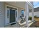 Inviting front porch with chairs, detailed trim, and a neatly landscaped yard at 2905 Cavalcade Cir, Johns Island, SC 29455