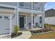Inviting front porch with chairs, detailed trim, and a neatly landscaped yard at 2905 Cavalcade Cir, Johns Island, SC 29455
