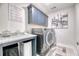 Modern laundry room features front load washer and dryer, ample storage, and stylish countertop space at 2905 Cavalcade Cir, Johns Island, SC 29455