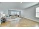 Spacious living room with a large sectional sofa, hardwood floors, and plenty of natural light at 2905 Cavalcade Cir, Johns Island, SC 29455