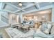 Bright open concept living room featuring a coffered ceiling, hardwood floors, and neutral decor at 2905 Cavalcade Cir, Johns Island, SC 29455