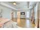 Open main bedroom with large windows, hardwood flooring, and an ensuite bathroom and walk-in closet at 2905 Cavalcade Cir, Johns Island, SC 29455