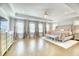Luxurious main bedroom with hardwood floors, tray ceilings, custom drapes, and neutral decor at 2905 Cavalcade Cir, Johns Island, SC 29455