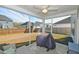 The screened porch has comfortable seating and views of the backyard and the fence at 2905 Cavalcade Cir, Johns Island, SC 29455