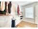 Bright walk-in closet with wood floors, built-in shelving, and a window providing natural light at 2905 Cavalcade Cir, Johns Island, SC 29455