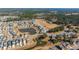 Scenic aerial view of a planned community featuring a pond, green spaces, and many single-Gathering homes at 292 Lotz Dr, Summerville, SC 29483