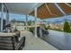 Inviting covered back porch boasts an awning, comfortable seating, and scenic water views at 292 Lotz Dr, Summerville, SC 29483