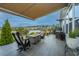 Relaxing covered back porch with wood flooring, fire pit, and outdoor cooking area overlooking the water at 292 Lotz Dr, Summerville, SC 29483