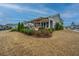 This home features a covered patio, a swing, and manicured shrubbery at 292 Lotz Dr, Summerville, SC 29483