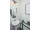 Stylish powder room featuring pedestal sink, round mirror, and modern decor at 292 Lotz Dr, Summerville, SC 29483