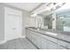 Bright bathroom featuring double door storage and granite countertop vanity with large mirror at 292 Lotz Dr, Summerville, SC 29483