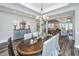 Spacious dining room with wood flooring, a large wooden table and chairs, and modern chandelier lighting at 292 Lotz Dr, Summerville, SC 29483